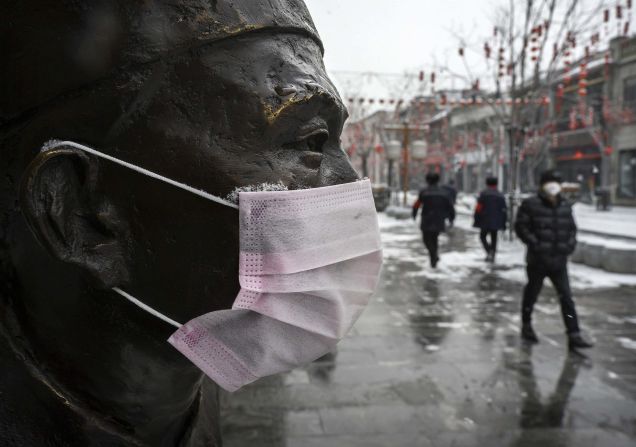 A mask is seen on a statue in Beijing on February 5, 2020.