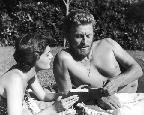 Douglas enjoys a book with his second wife, Anne Buydens, circa 1956. The two were married in 1954 and remained married until his death.
