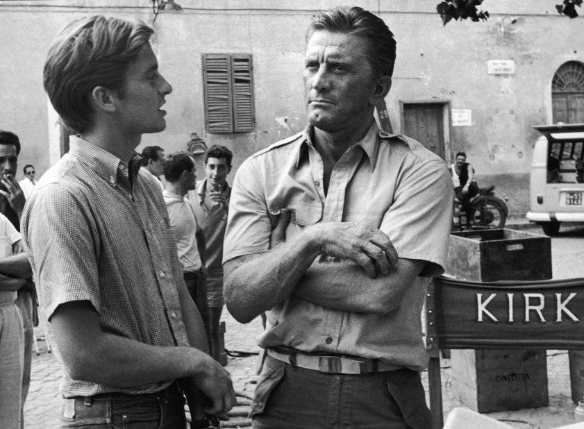 Douglas appears with his son Michael on the set of the film "Cast a Giant Shadow" in Rome in the mid-'60s. Michael Douglas had a small uncredited role in his dad's movie. He would go on to become a major film star himself in the 1980s and '90s.