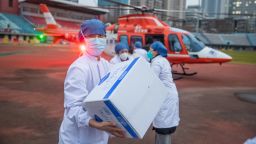 Medical staff carry medical materials from a helicopter in Wuhan, China, on February 1, 2020.