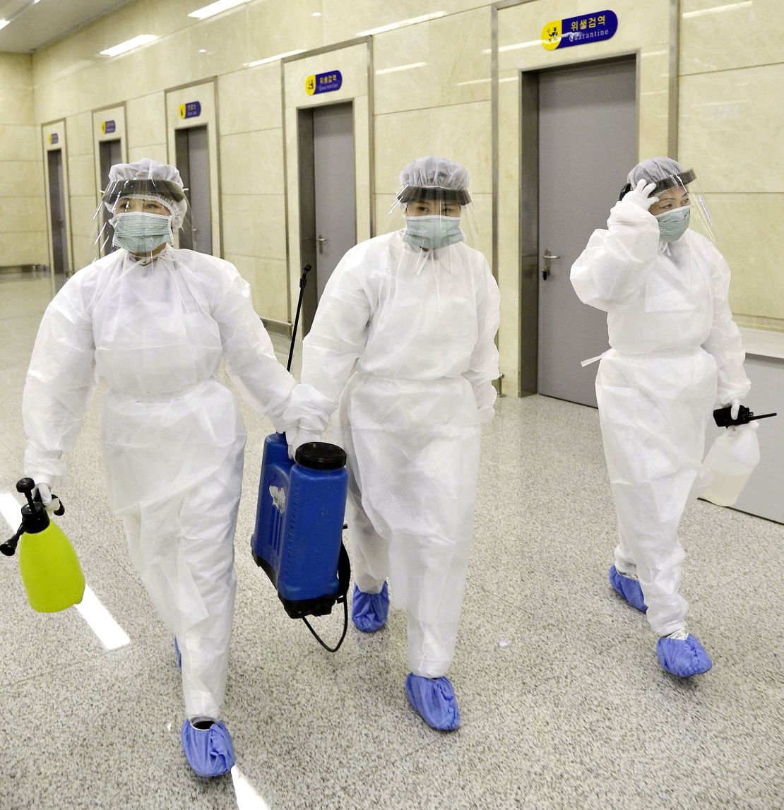 Quarantine staff in protective gear are pictured at Pyongyang International Airport on Saturday.