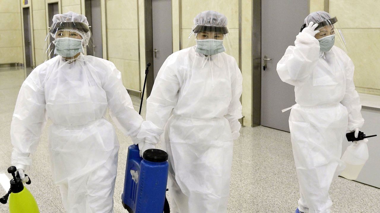 Quarantine staff in protective gear are pictured at Pyongyang International Airport on Saturday.
