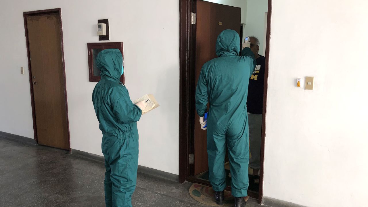 Medical workers screen the temperatures of foreign nationals using thermal imaging devices in the diplomatic area of Pyongyang on Monday.