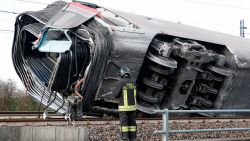 A firefighter inspects a derailed train carriage, near Lodi, northern Italy, Thursday, Feb. 6, 2020. Italian authorities say a high-speed passenger train has derailed in northern Italy, killing two railway workers and injuring 27 people.