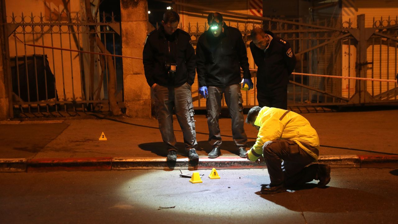 Israeli police officers inspect the scene of an attack in Jerusalem, early Thursday, Feb. 6, 2020. A Palestinian motorist slammed his car into a group of soldiers early on Thursday, wounding more than a dozen before fleeing the scene, Israeli police said. (AP Photo/Mahmoud Illean)