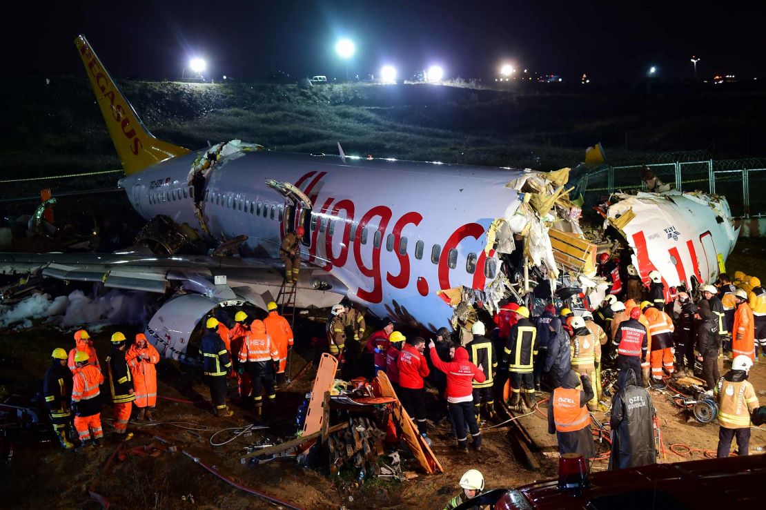 Rescuers work to reach injured passengers on the Pegasus Airlines jet on Wednesday night.