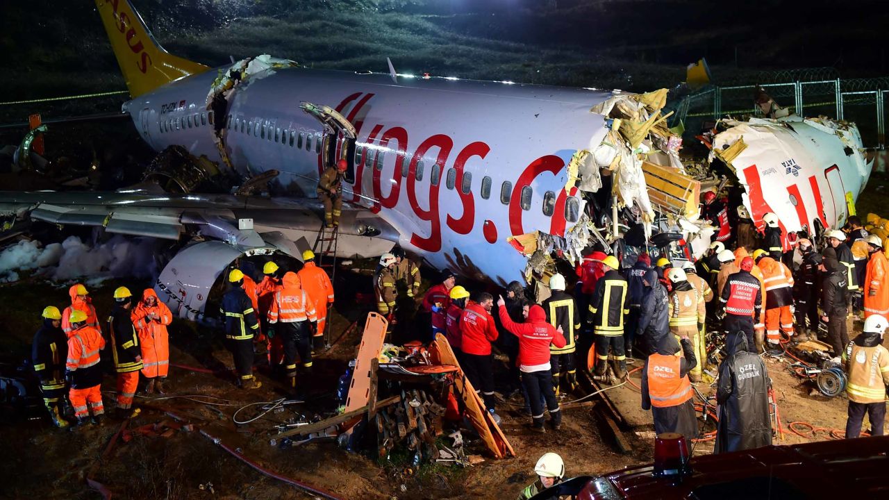 Rescuers work to reach injured passengers on the Pegasus Airlines jet on Wednesday night.