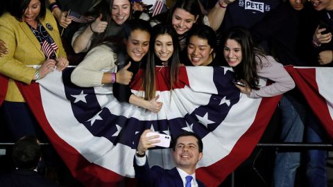Buttigieg takes a selfie with supporters after speaking at a caucus night campaign rally, Monday, February 3, in Des Moines, Iowa.