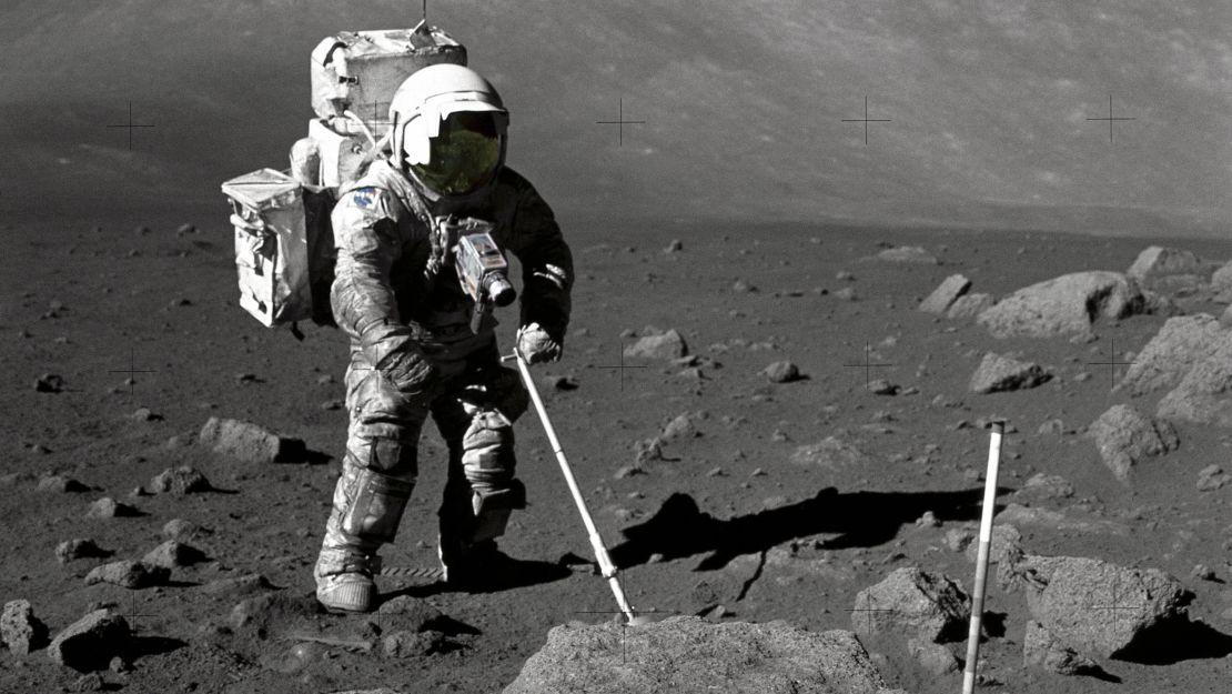 Astronaut Harrison Schmitt retrieves lunar samples during Apollo 17.
