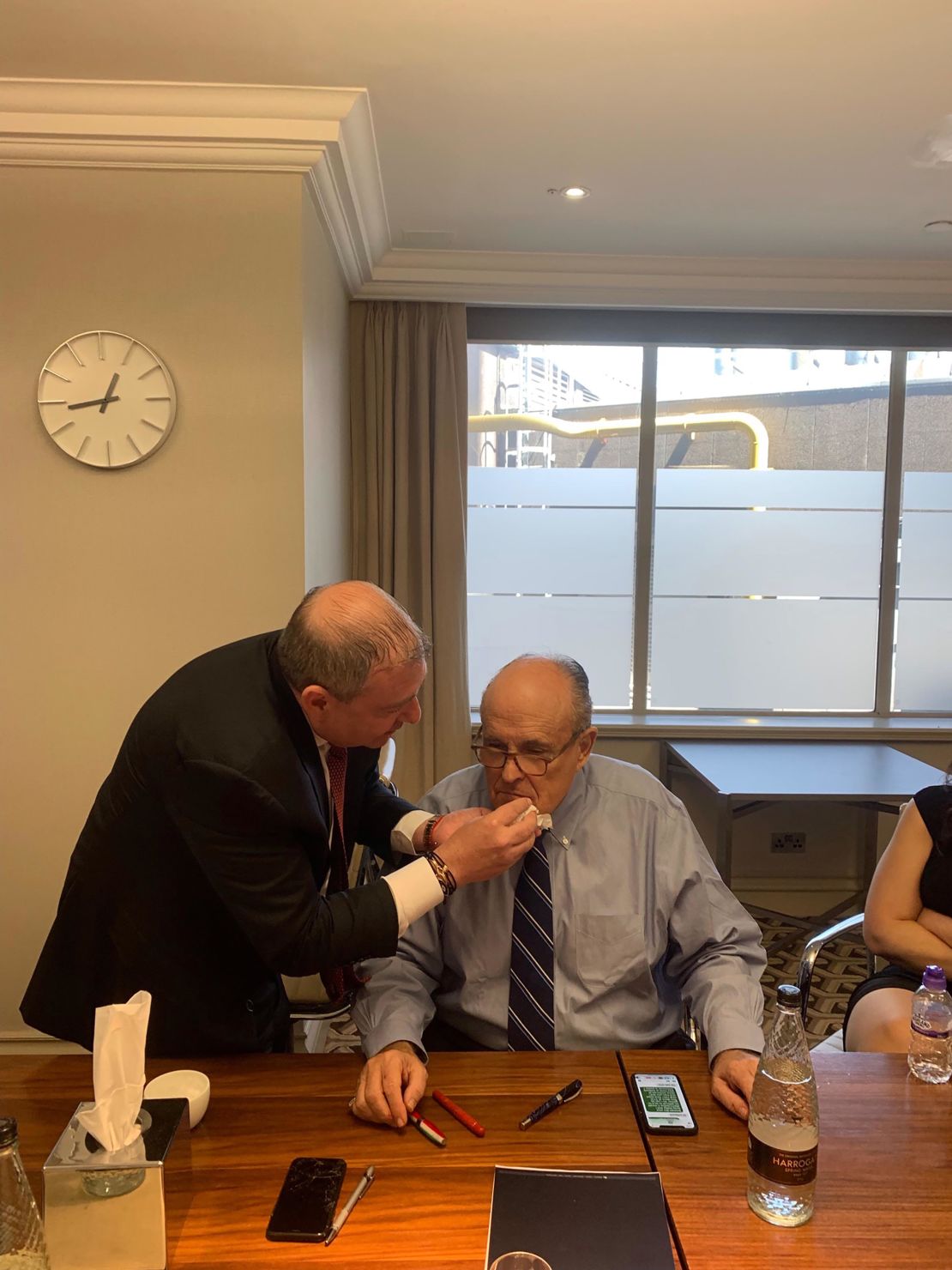 Lev Parnas wipes Giuliani's face in London in 2019.