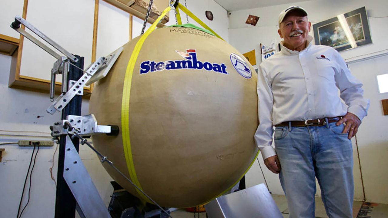 Project manager and financier Tim Borden stands next to the record-breaking firework shell.