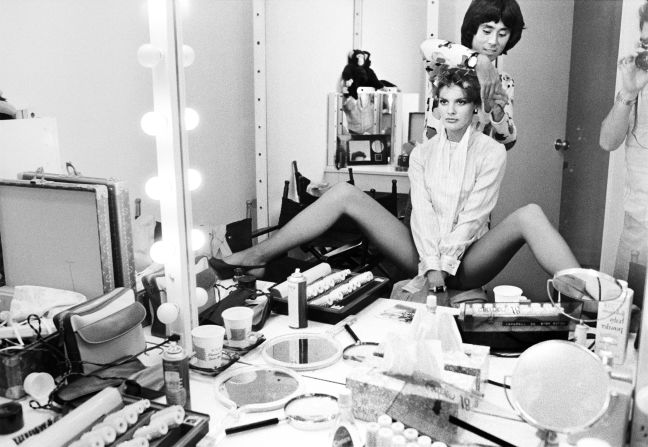 Rene Russo and Suga photographed in a dressing room.