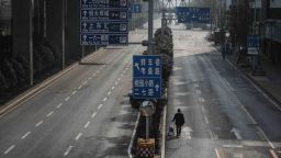 WUHAN, CHINA - FEBRUARY 05: A man drags a handcart across a road on February 5, 2020 in Wuhan, Hubei province, China. Flights, trains and public transport including buses, subway and ferry services have suffered disruption for two weeks.  (Photo by Getty Images)