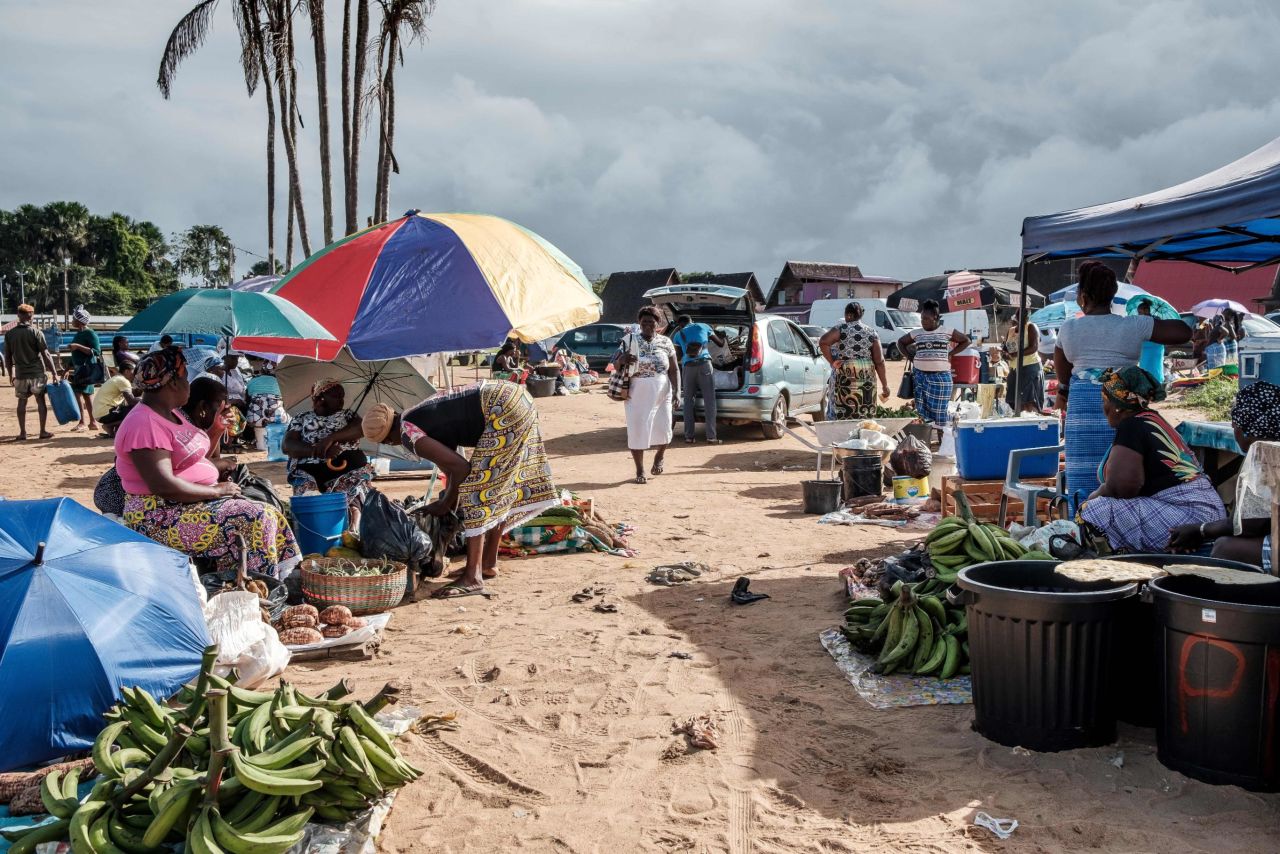 Produce sellers create a makeshift market located on the shore in Saint-Laurent du Maroni, Guyane.