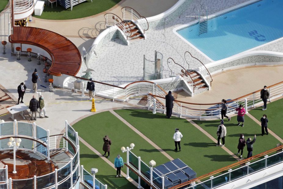 Passengers are seen on the deck of the Diamond Princess cruise ship, docked at the Yokohama Port on February 7.