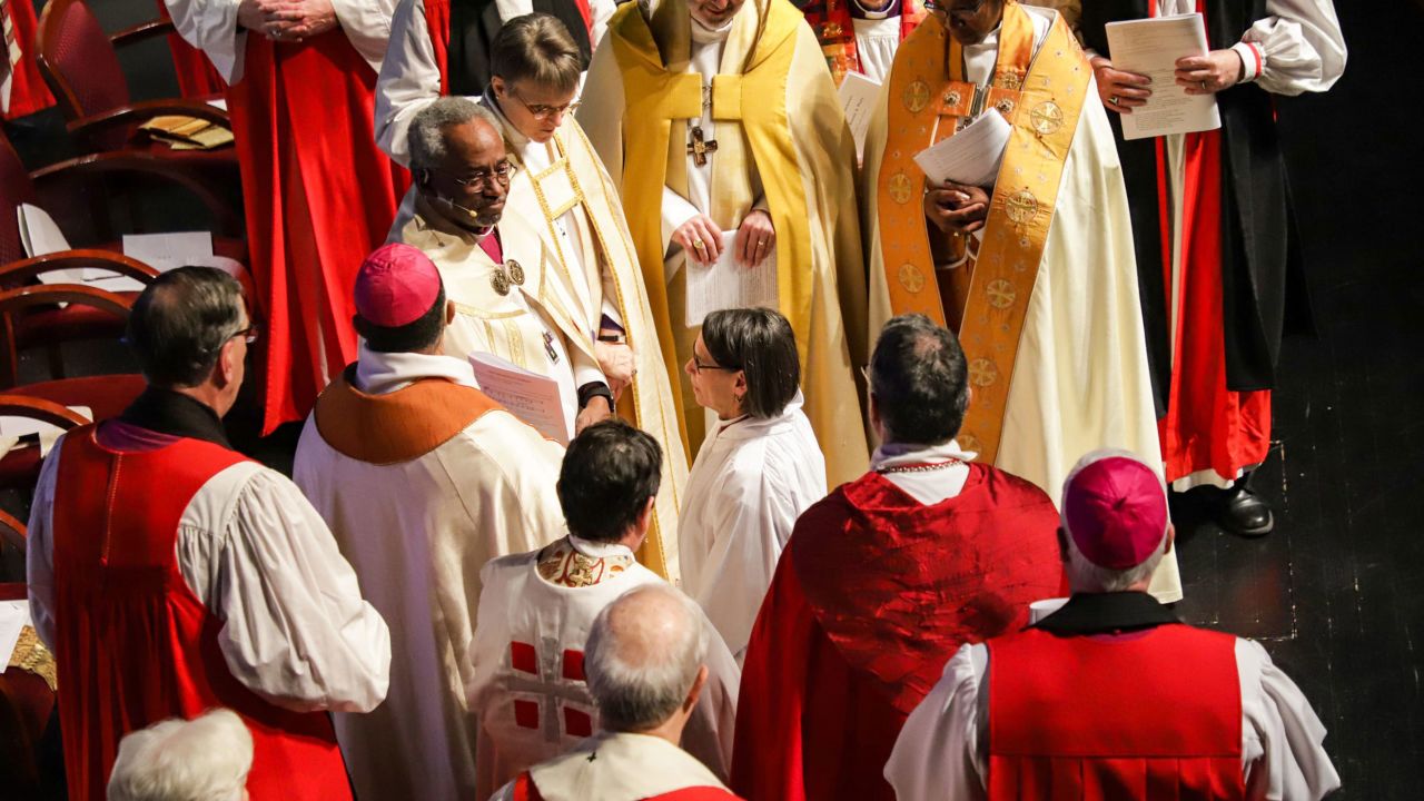 Dr. Bonnie Perry kneels before the presiding bishop, while surrounded by other bishops, during a service on Saturday in which Perry was ordained as the 11th bishop of the Episcopal Diocese of Michigan.
