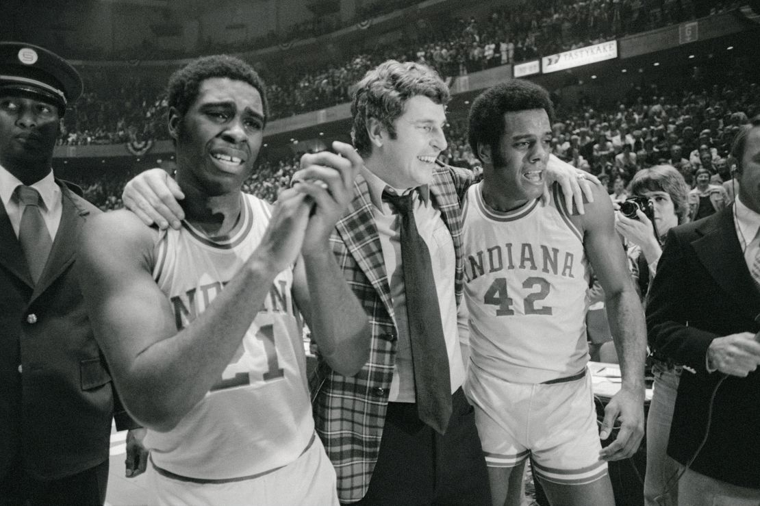 Indiana coach Bobby Knight, center, is walked off the court in jubilation by a tearful Quinn Buckner, left, and Scott May after the Hoosiers won the 1976 NCAA championships in Philadelphia.