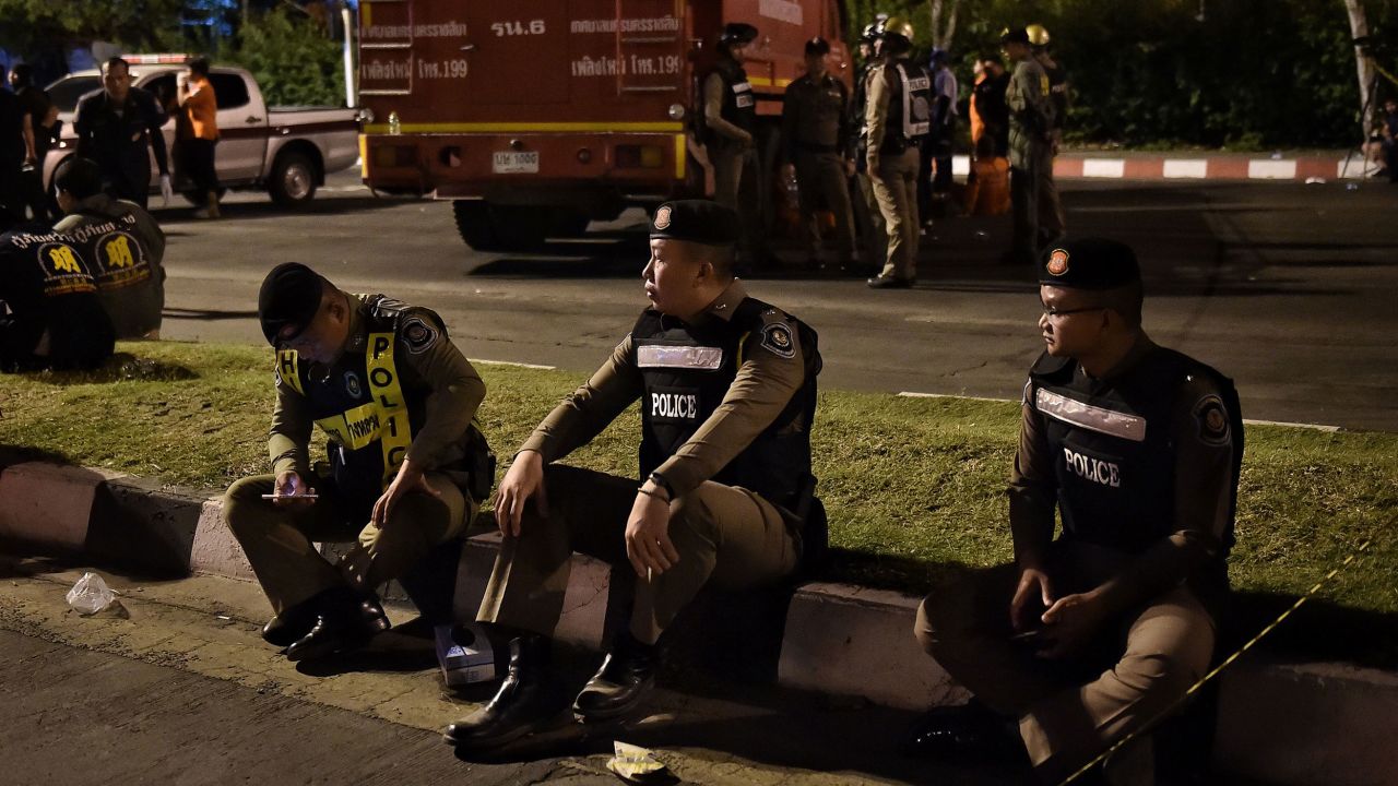 Police rest outside the Terminal 21 shopping mall after the shooting.