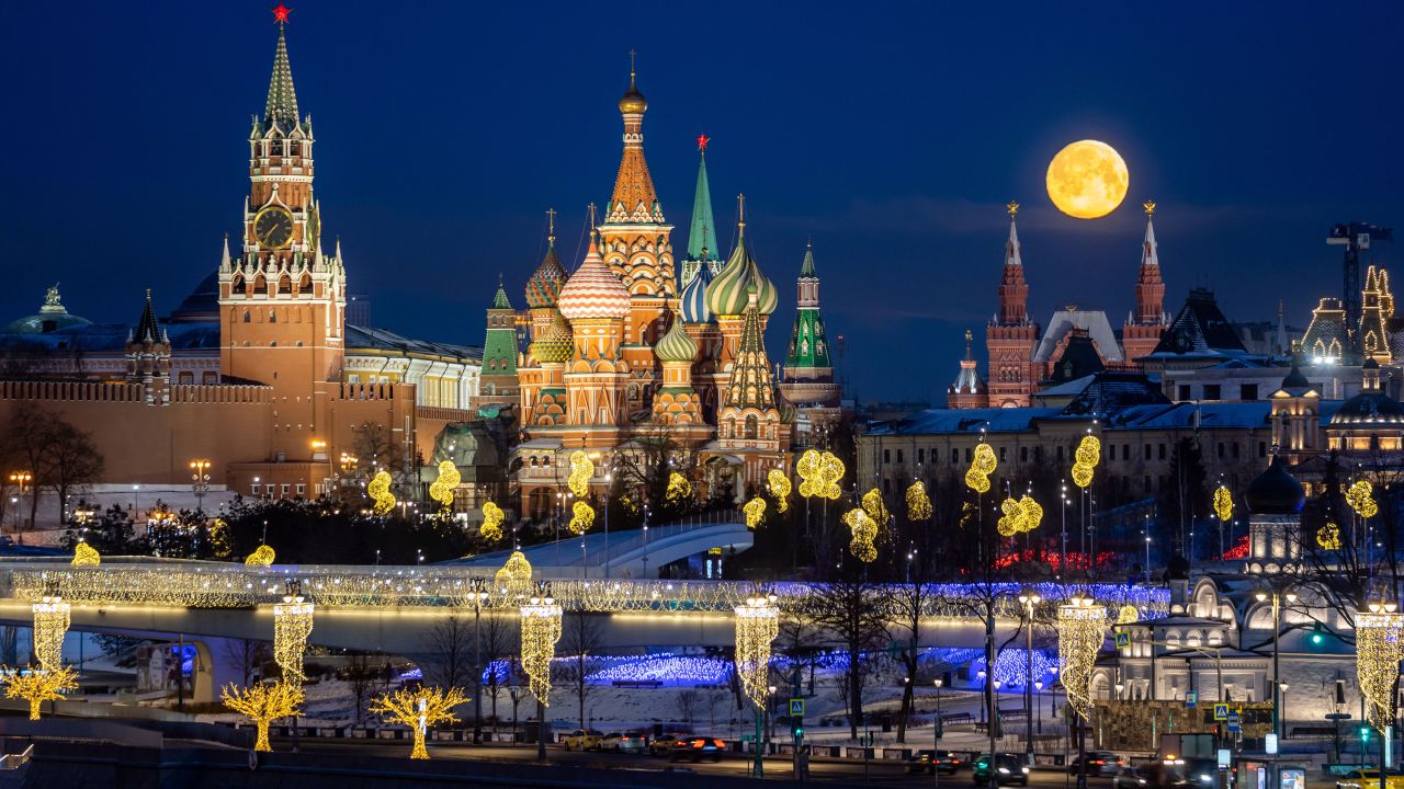 The moon lights up the sky over the Moscow.