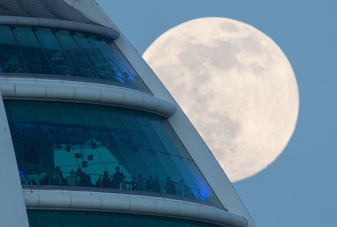 The moon rises behind the Spinnaker Tower in Portsmouth, England.