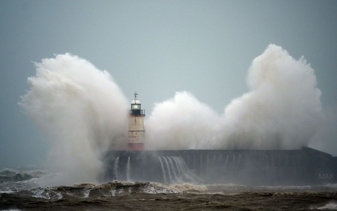 Waves crash over a lighthouse on the south coast of England on February 9, 2020, as Storm Ciara hits the UK.  