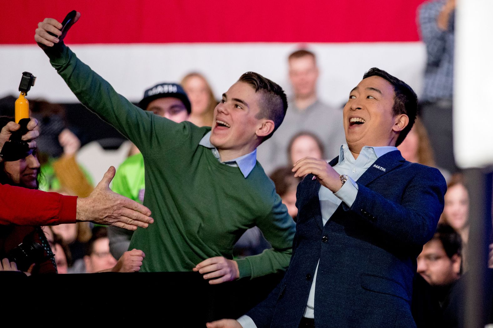 Democratic candidate Andrew Yang takes a photo with an audience member as he arrives at an "Our Rights, Our Courts" forum in Concord, New Hampshire, on February 8.