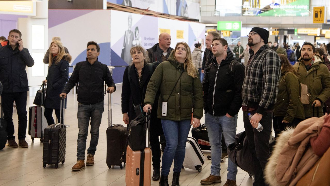 Travelers wait in the departure hall of Schiphol airport on February 9, 2020. Many flights there have been canceled due to Storm Ciara. 