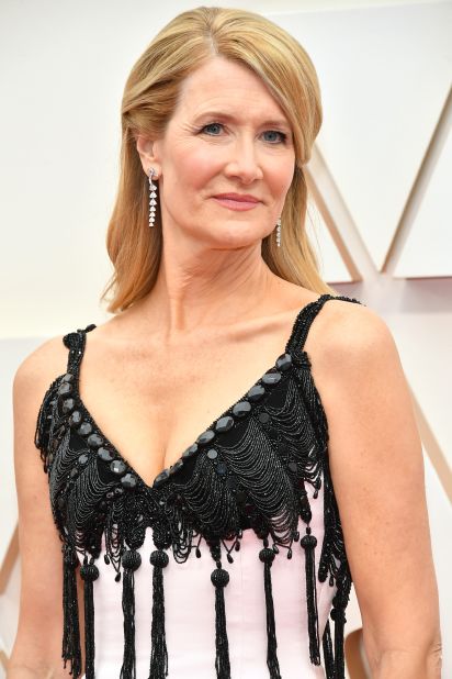 Laura Dern looks glamorous in a pink gown with black bustier custom made by Armani Prive. 