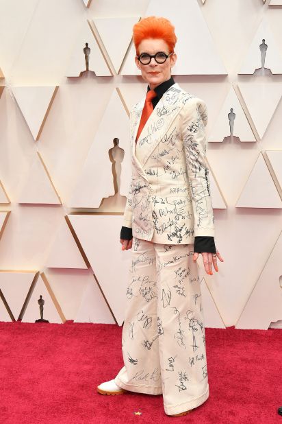 Costume designer Sandy Powell wears the same two-piece suit she donned at the BAFTAs, continuing her effort to collect signatures -- over 100 so far -- from A-list celebrities to transform the outfit into a piece of art. Powell plans to auction the outfit through the Art Fund charity to raise money to purchase and maintain Prospect Cottage, the home of her late friend and mentor Derek Jarman.<br />