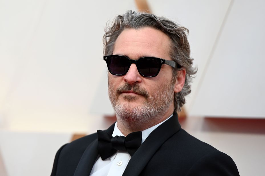 In January, Joaquin Phoenix announced that he would wear only one Stella McCartney tuxedo on the 2020 awards red carpet to promote sustainable fashion. He's kept his word. Tonight he's appeared dressed in the same plain black tux (which he also wore to the BAFTAs, the Golden Globes and to the SAG Awards). 