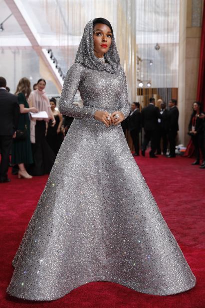The shiniest dress on the red carpet? Janelle Monae attends the Oscars in a glittering silver-hooded dress. The gown is by Ralph Lauren, and apparently took 600 hours to make.  