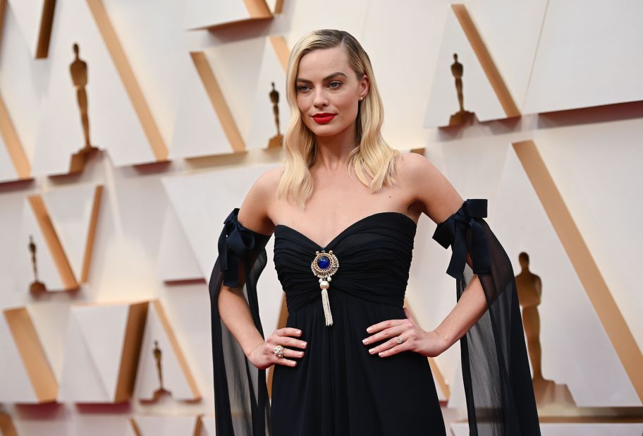 Margot Robbie, who has a nomination for Best Supporting Actress for her role in "Bombshell," stepped out in a vintage strapless navy Chanel dress with a jewel pendant and cuff sleeves.