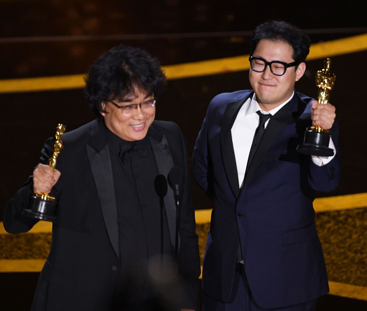 "Parasite" director Bong Joon Ho, left, and Han Jin Won accept the Oscar for best original screenplay.