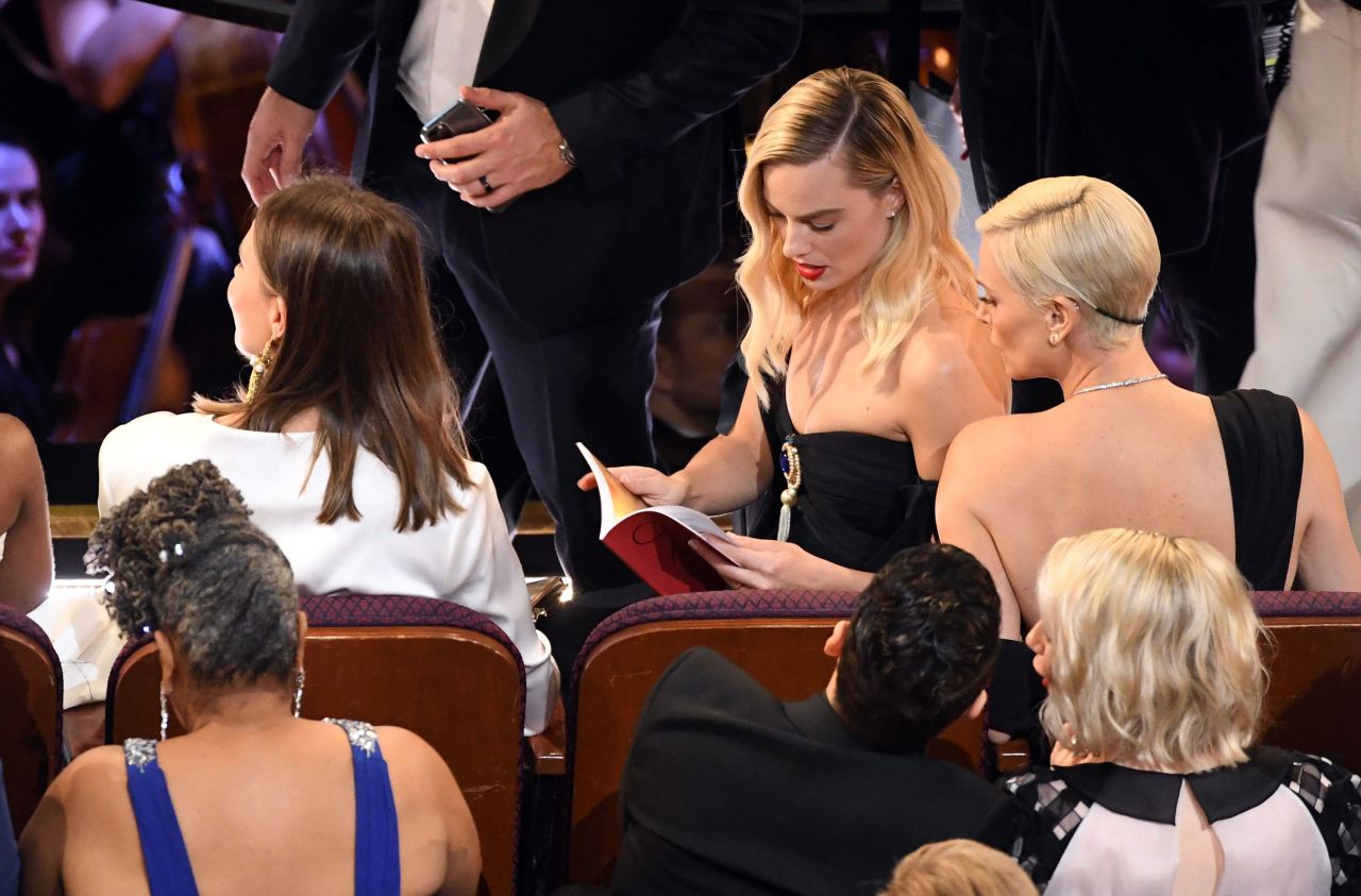 "Bombshell" co-stars Charlize Theron, right, and Margot Robbie sit together during the show.