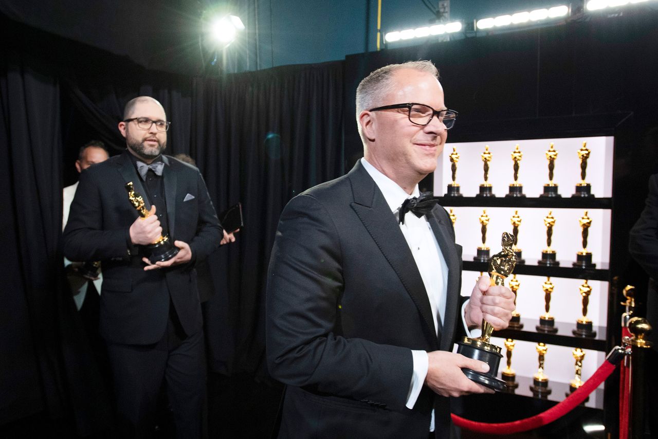 "Toy Story 4" producers Josh Cooley and Mark Nielsen walk backstage with the Oscar for best animated feature film.