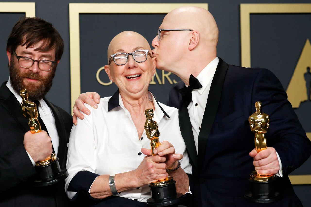 From left, Steven Bognar, Julia Reichert and Jeff Reichert pose with the Oscar for best documentary feature ("American Factory"). It is the first Netflix film produced by Barack and Michelle Obama's production company "Higher Ground." 