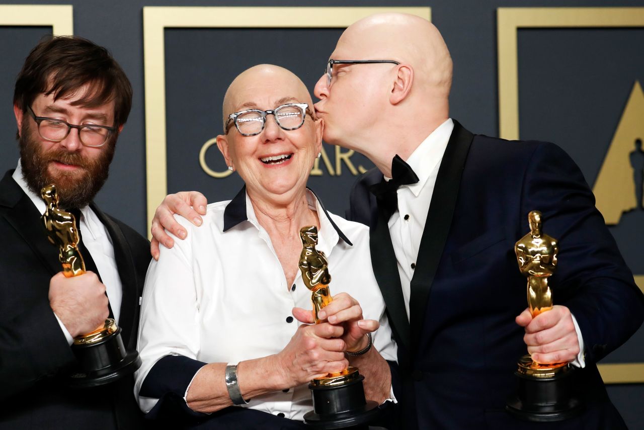 From left, Steven Bognar, Julia Reichert and Jeff Reichert pose with the Oscar for best documentary feature ("American Factory"). It is the first Netflix film produced by Barack and Michelle Obama's production company "Higher Ground."