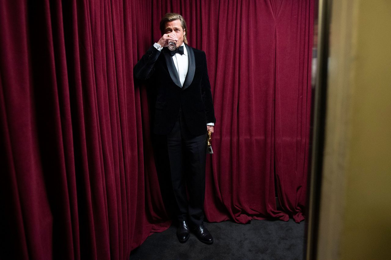 Brad Pitt stands backstage at the show.