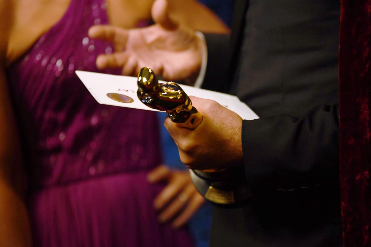 "Jojo Rabbit" director Taika Waititi holds his Oscar backstage for best adapted screenplay.