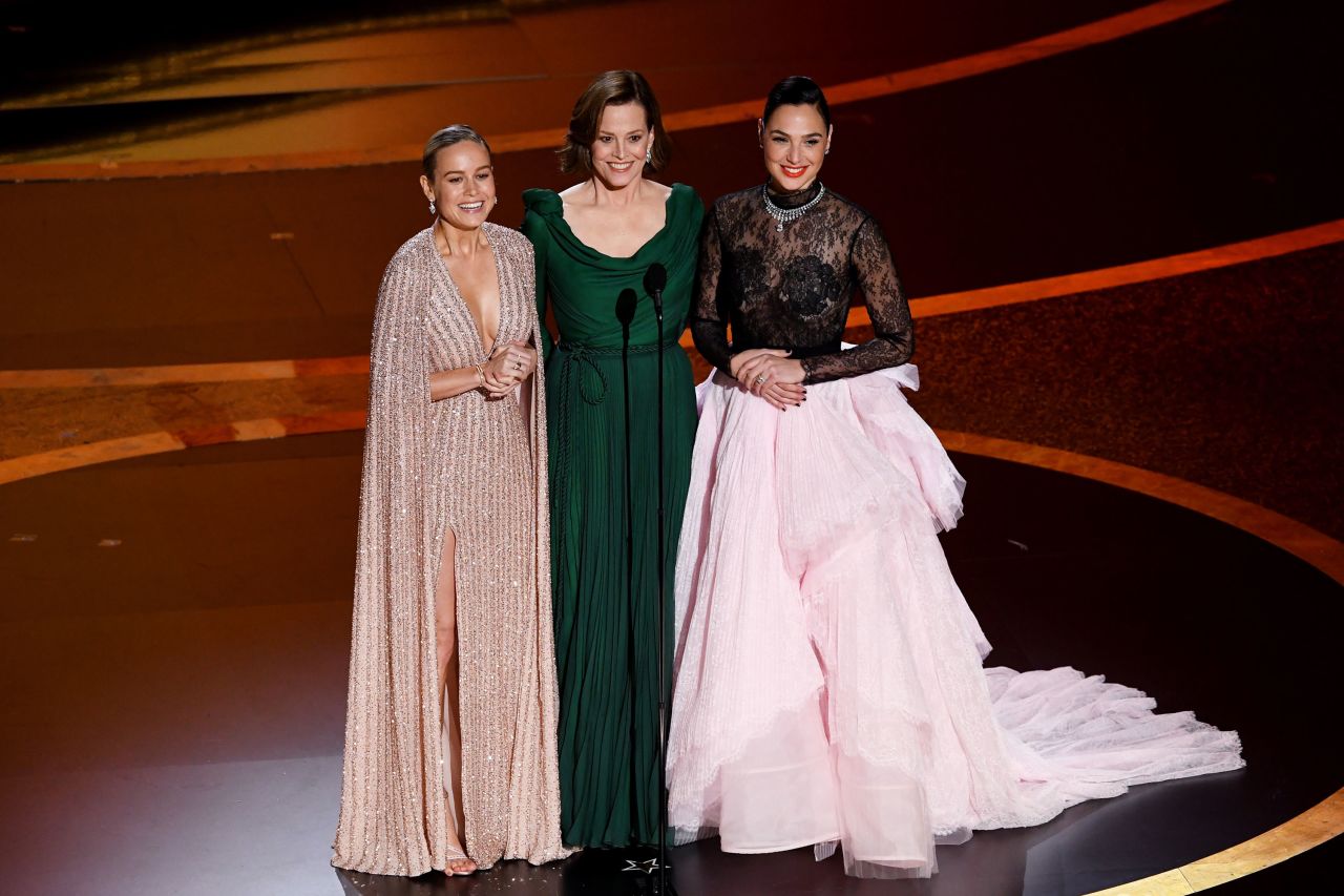 From left, Brie Larson, Sigourney Weaver and Gal Gadot present an award.