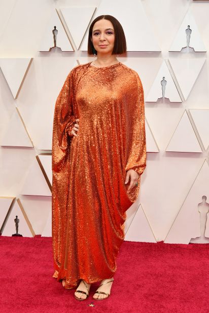 Maya Rudolph lights up the red carpet in a copper, sequin-covered Valentino cape dress.