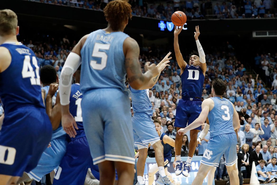 Duke guard Tre Jones shoots over North Carolina players to send the rivalry game into overtime on Saturday, February 8. Duke won 98-96 when freshman Wendell Moore Jr. scored another buzzer-beater in the extra frame.