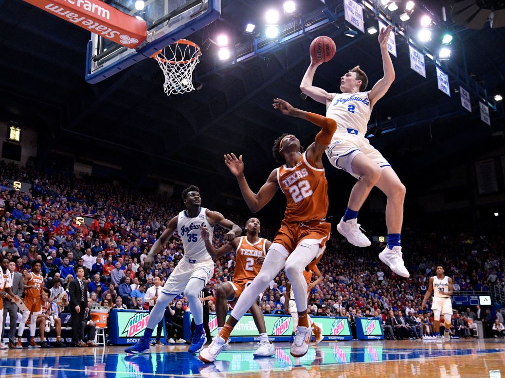 Kansas' Christian Braun is fouled by Texas' Kai Jones during a college basketball game in Lawrence, Kansas, on Monday, February 3.