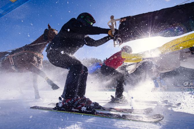 Skiers are pulled by horses during a skijoring race in St. Moritz, Switzerland, on Sunday, February 9.