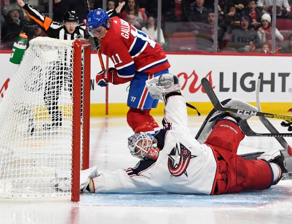 Columbus goalie Elvis Merzlikins makes a goal-line save against Montreal's Brendan Gallagher during an NHL game on Sunday, February 2.