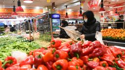 People buy vegetables in a supermarket in Yunyang County in southwest China's Chongqing, Feb. 5, 2020. 