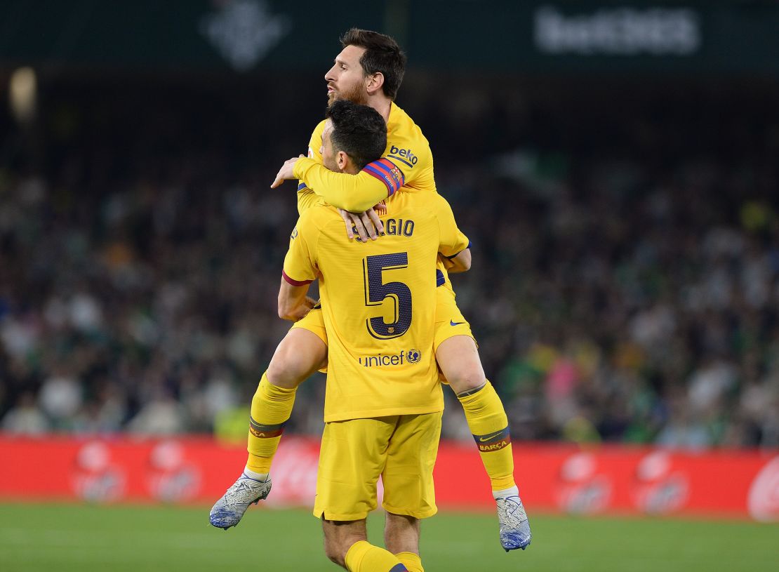 Sergio Busquets holds Messi aloft after equalizing for Barcelona.