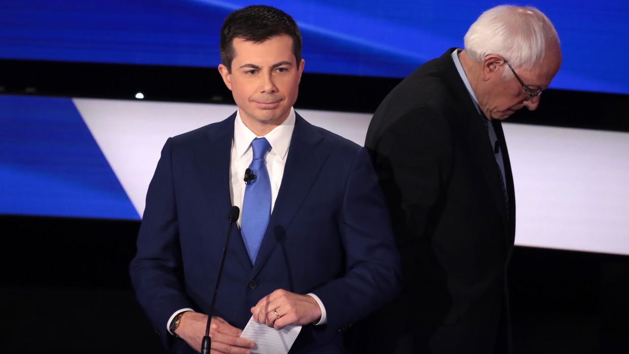 Pete Buttigieg and Sanders take a break during the Democratic presidential primary debate at Drake University on January 14, 2020 in Des Moines, Iowa.