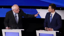 Former South Bend, Indiana Mayor Pete Buttigieg (R) listens as Sen. Bernie Sanders (I-VT) makes a point during the Democratic presidential primary debate at Drake University on January 14, 2020 in Des Moines, Iowa. 