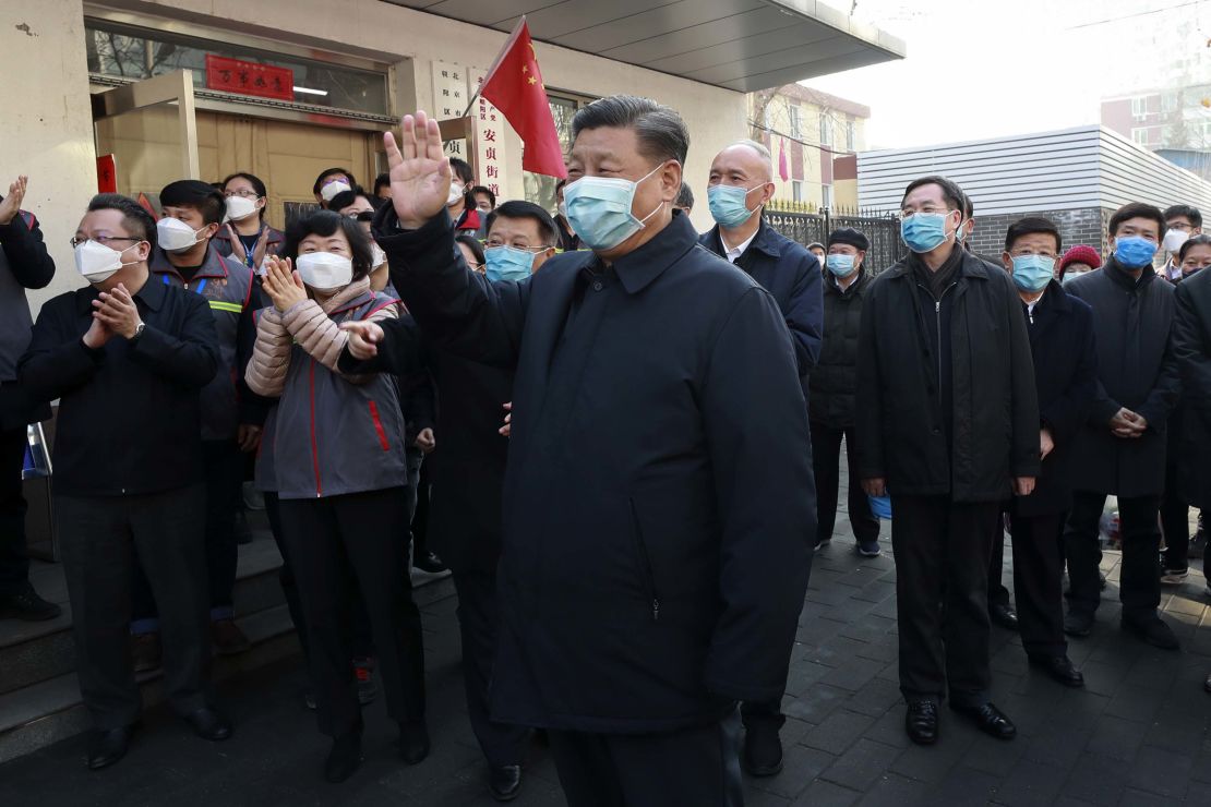 Chinese President Xi Jinping wearing a protective face mask waves as he inspects the novel coronavirus pneumonia prevention and control work at a neighbourhoods in Beijing on February 10.